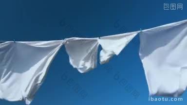 蓝色的天空衬托着晾衣绳上晾晒的白色衣物